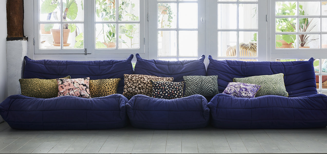 Home Soft Furnishing - navy sofa with lots of colourful cushions
