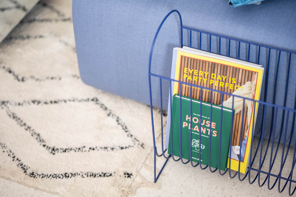 organizing baskets, home storage - blue magazine holder with books in